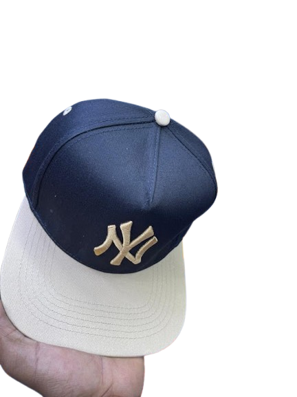 New York Yankees Interlocking NY Snapback Cap – Black & Cream with Gold Logo